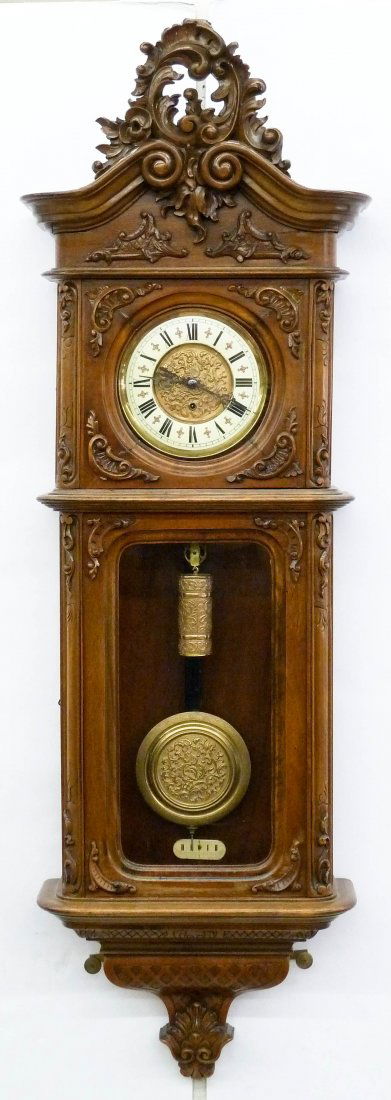 Impressive Gustav Becker German Vienna Regulator Wall: Impressive Gustav Becker German Vienna Regulator Wall Clock 52''x17''x7''. Ornately carved walnut case with single weight drive. Decorated pendulum with matching weight. Movement is marked and numbere