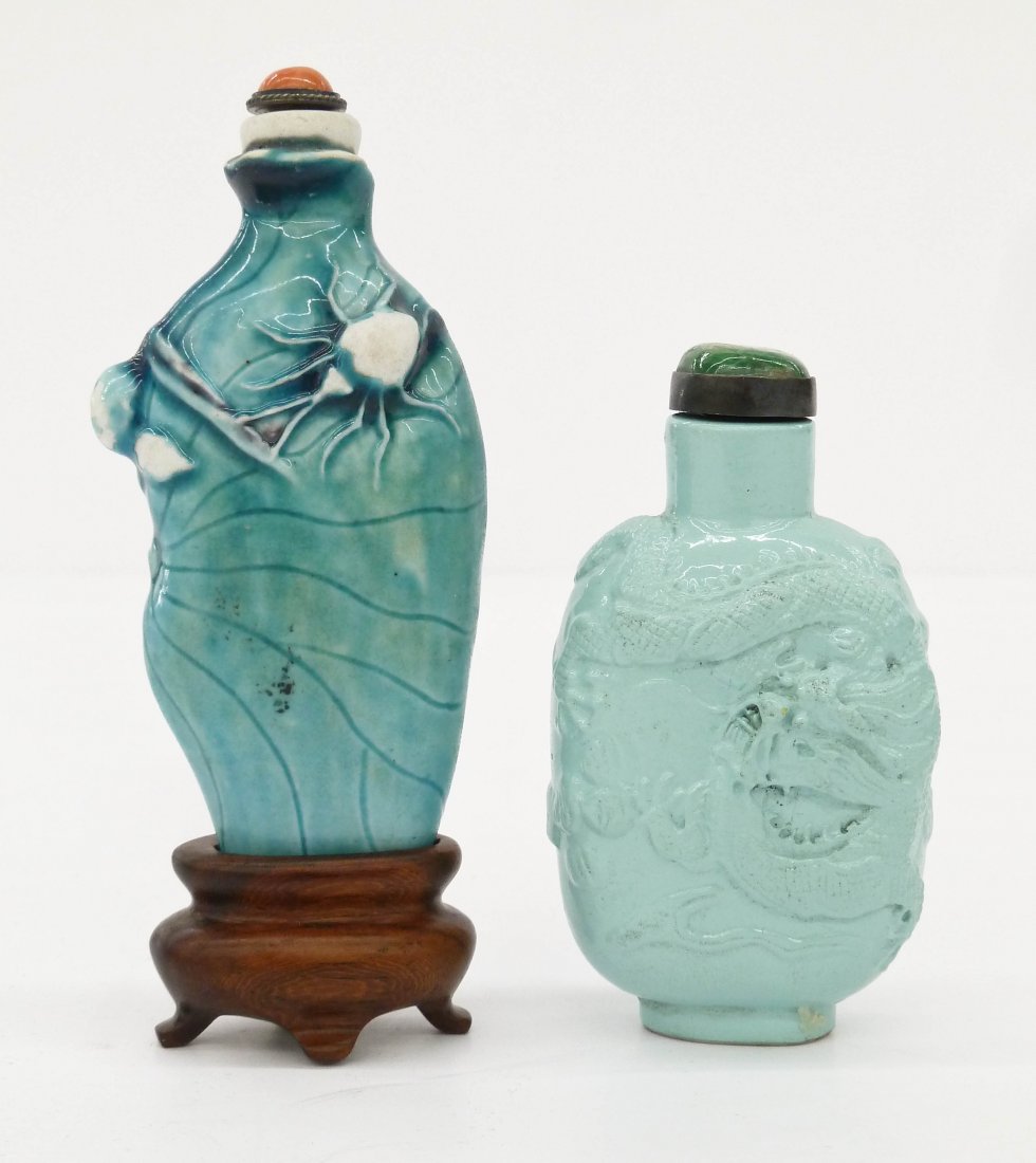 2pc Antique Chinese Porcelain Snuff Bottles. Includes a: 2pc Antique Chinese Porcelain Snuff Bottles. Includes a molded turquoise five-clawed dragon bottle with jadeite top 2.75''x1.5'' and a molded lotus flower pod with beetle bug snuff coral top 3.5''x1.5