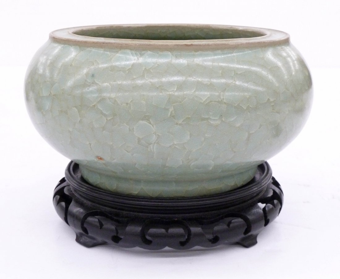 Old Chinese Ice Crackle Celadon Ceramic Censer 4''x8''.: Old Chinese Ice Crackle Celadon Ceramic Censer 4''x8''. Pale celadon ice crackle glaze. Bottom has five spur marks. It comes with pierced carved rosewood stand. A small glaze pop and .5'' chip to side