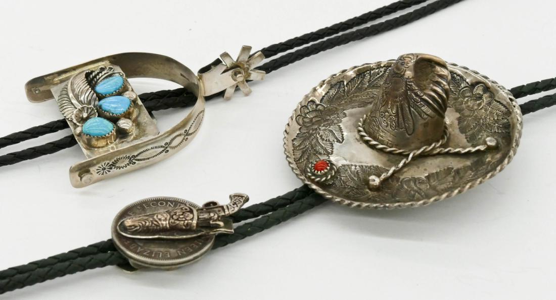 2pc Southwest Silver Figural Bolo Ties. Includes a: 2pc Southwest Silver Figural Bolo Ties. Includes a silver spur set with turquoise by G. Gomez 3''x2.25'' and a Mexican sombrero set with a piece of coral 3'' with a gun holster on coin 1.5''. Excellen