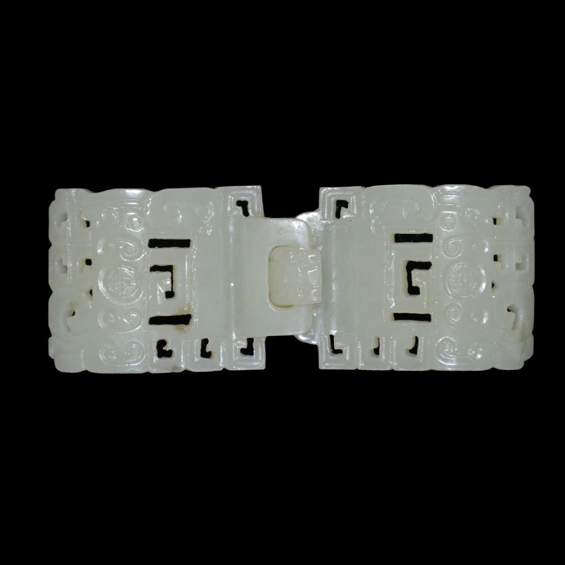 White Jade Belt Buckles: 和田白玉镂雕如意几何纹带钩 White Jade Belt Buckles Reticulated with ruyi scrolls and geometric design. Height: 1⅝ in