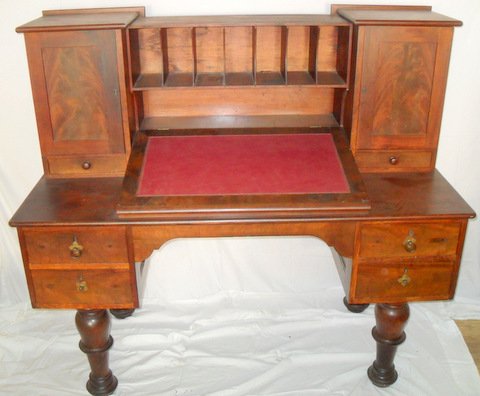 Early American Walnut Plantation Desk: Slant lid leather writing surface, double door matching file cabinet, pigeon hole center, four large base drawers, period hardware, resting on bold turned post legs. Manufactured by Stephen Smith Co. 
