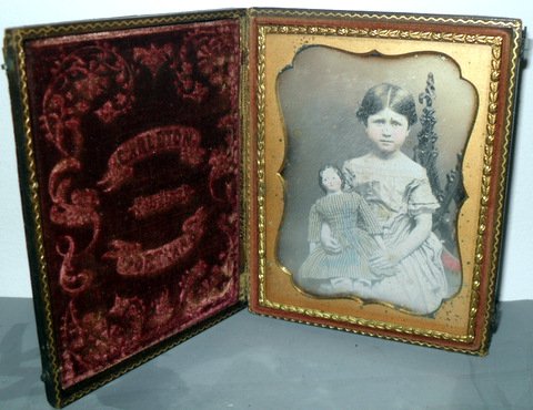 1/4 Plate Daguerreotype of Young Girl: Rare Portland Maine 1/4 Plate Daguerreotype of Young Girl With Covered Wagon China Head Doll, Circa 1850 Quarter plate daguerreotype of young girl approximately 10 years old holding a covered wagon st