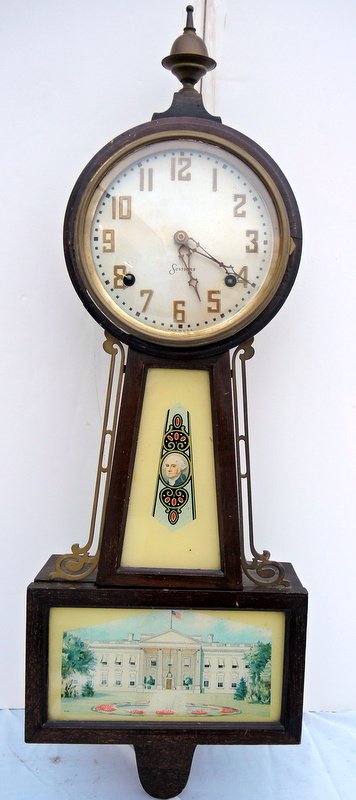 Sessions Mount Vernon Banjo Clock: Mahogany case with brass returns. Original patriotic glass tablets, silvered dial and brass numerals. Original condition. 28 1/2" long