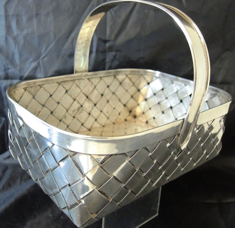 Cartier Sterling Silver Hand Made Table Basket: Woven rectangular basket with overshot handle. Signed "Cartier Hand Made Sterling". Total weight: 18 1/2 troy oz. 9 3/4" x 7" x 7 1/2" tall