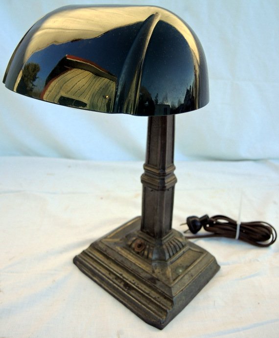 Victorian Emeralite Banker's Desk Lamp: Circa 1920's era. Bronzed base with adjustable cased green hood shade. Bronzed base has usual wear. 15" overall height. Base 6" x 7" rectangular