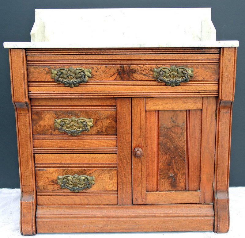 Victorian Walnut Marble Top Toilet Commode: Victorian 1860's era marble top commode with three drawers and single door base, original brass pulls completed with marble top and backsplash. 31" x 15" x 34" tall.