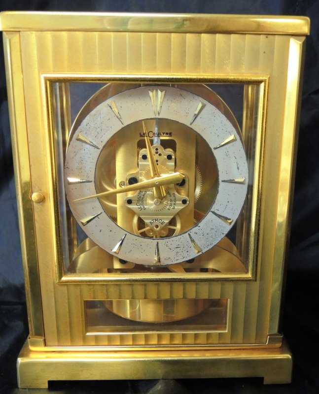 LeCoultre Atmos 15 Jewel Clock: Brass frame case, glass panel sides, silvered dial with gilded faceted numerals. 6 1/2" x 4 3/4" x 9". Removed from estate in working order