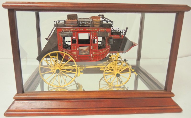 Superb Well's Fargo Replica Stage Coach Wagon: Assembled from kit form in 1970's with glass display case. 10" x 15" x 9" tall glass display case. Expertly rendered and painted
