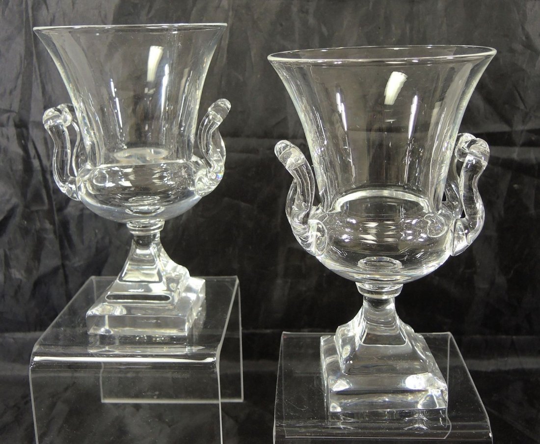Pair of Mid Century Steuben Campagna Style Urns: Flared top campagna style urns with applied handles on stepped square bases. Urns are 6 3/4" tall x 4 1/2" diameter. Both signed in script.