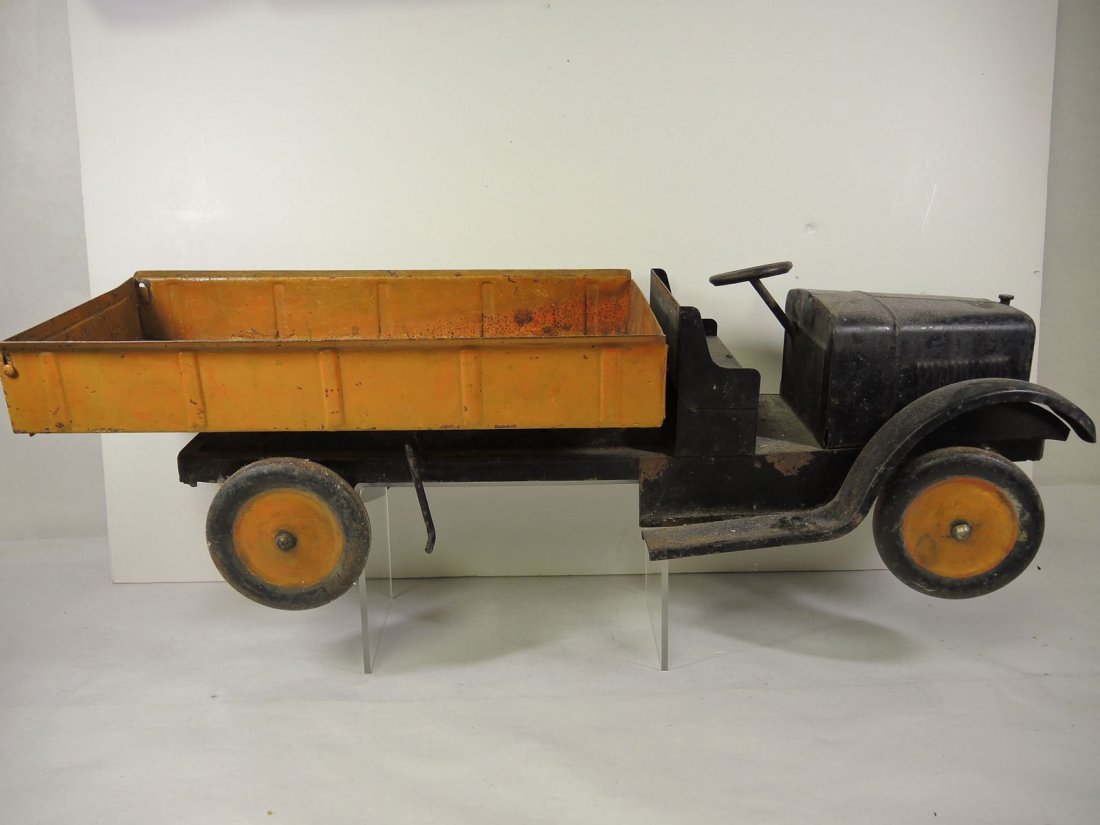 Dayton Toy Co Model T Era Dump Truck: The front end and chassis have original paint. The body and wheels have been repainted in the past. Steering wheel has been re-welded. 27" long.