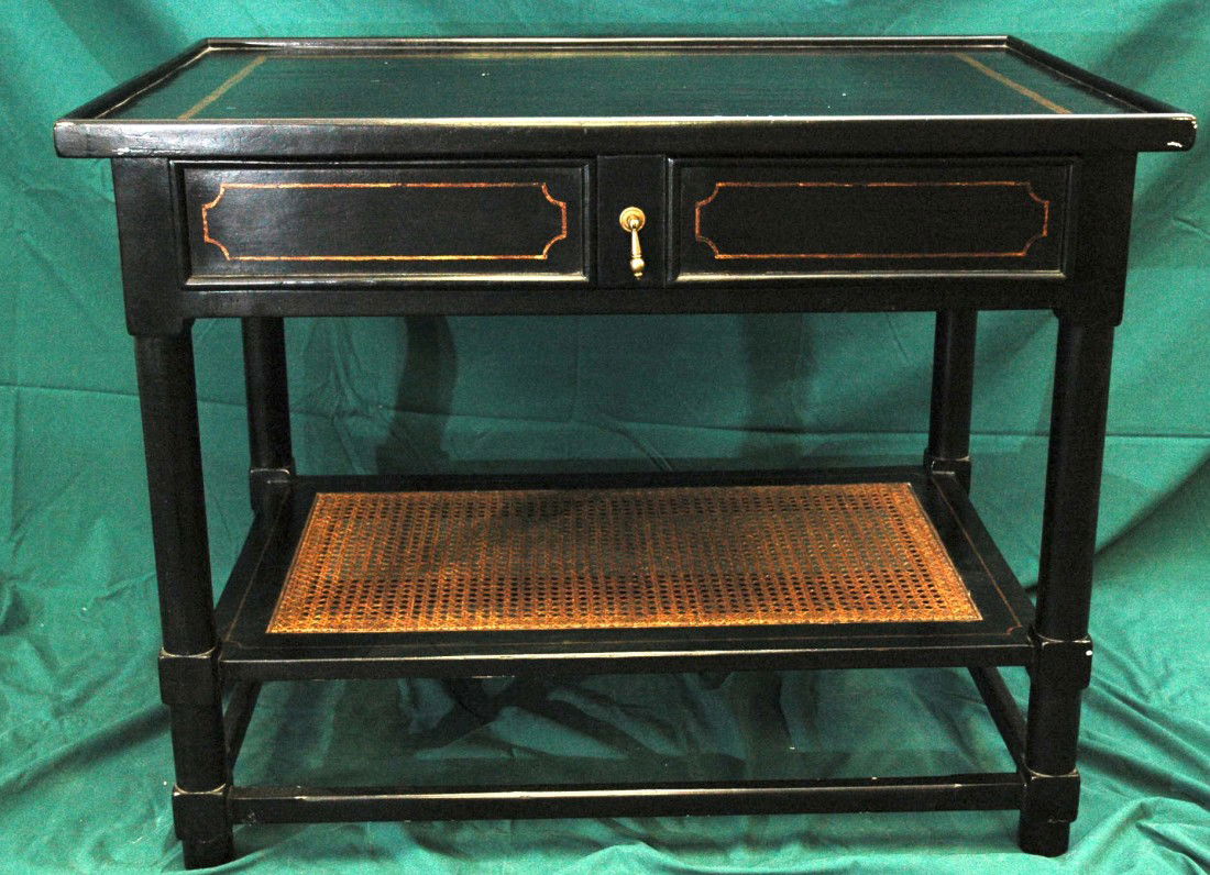 Black Table: Accent Table, Antique black crackle finish with antique gold accents. Table features a rattan bottom shelf and a large drawer in front. Dimensions: 36"W x 24"D x 28.5"H, Some small paint chips, otherw