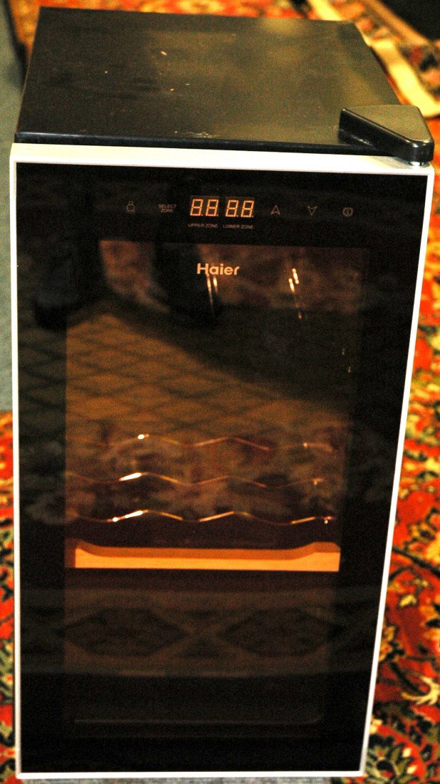 Haier Wine Cooler: Haier wine cooler with glass door. Capable of chilling nine wine bottles. In working condition 1.7 cubic feet capacity.