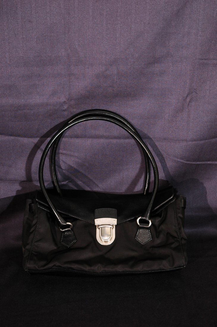 Prada Handbag: Black leather and vinyl Prada handbag. Previously used. Made in Italy.