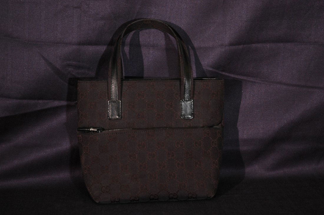 Gucci Handbag: Black Gucci monogrammed handbag previously used. Made in Italy.