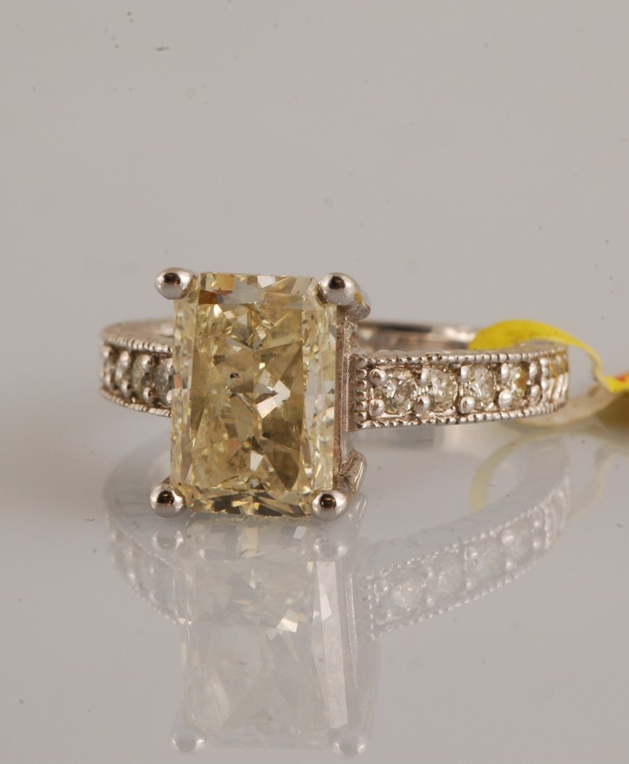 Solitaire Diamond (4.01 ct) Ring: 14K white gold solitaire diamond ring. Carat weight 4.01 of center stone, SI1 clarity, K-L color, no fluorescence. The ring also contains 8 round brilliant cut diamonds that are H-I color SI2-SI3 clar
