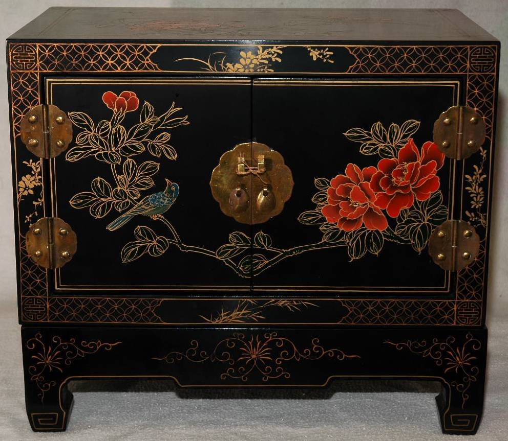Hand Painted Wooden Cabinet: Artfully hand painted dark wood cabinet with floral design in bright red and green. Two doors with metal hinges and lock ability. Supported by four legged wooden stand with hand painted golden accents