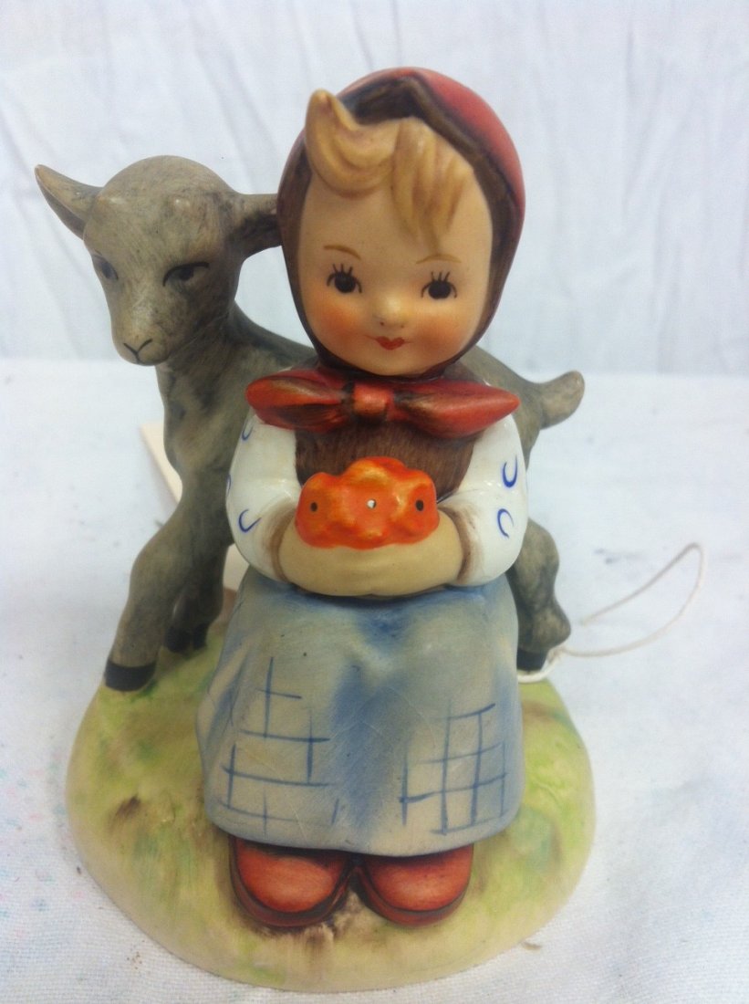 Hummel Figurine: Little girl holding flowers sitting with deer by Hummel. 4".