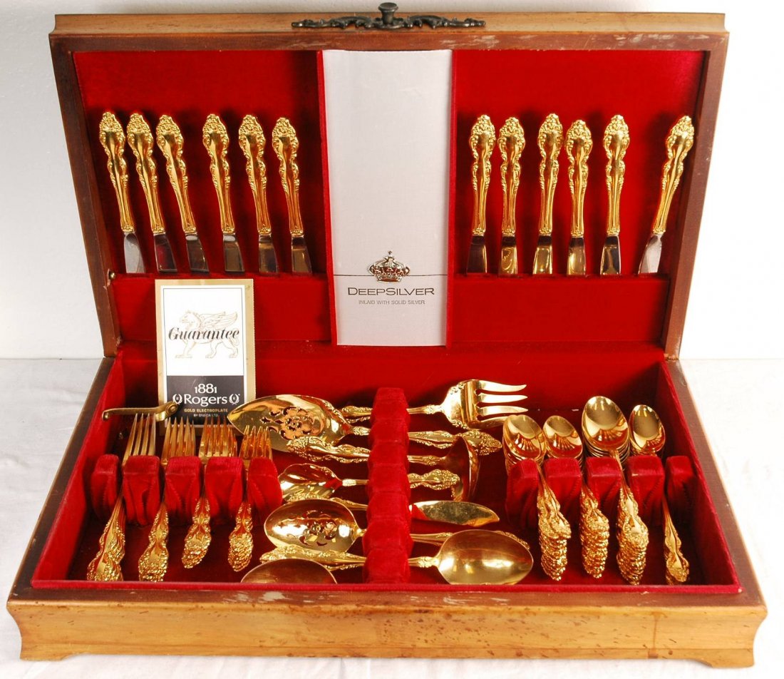 1881 Rogers Silverware Set: 88 Piece electroplate silverware set in velvet lined wooden case by 1881 Rogers by Oneida. Inside box is lined in red velvet with place settings to separate silverware. Original guarantee in case, Sta