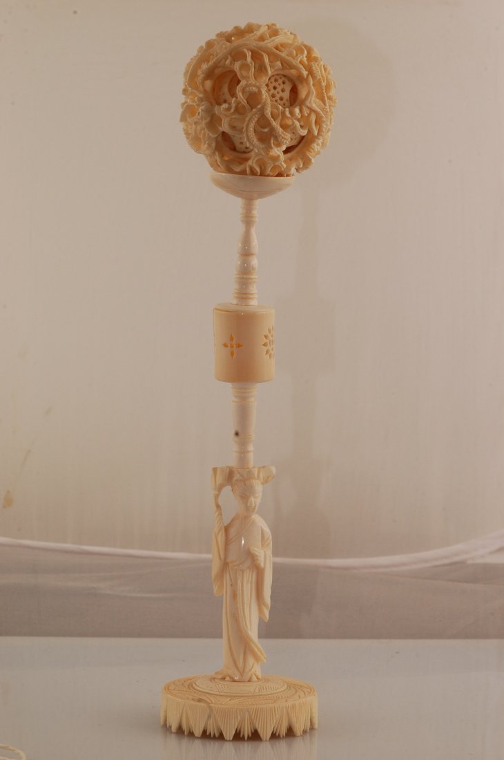 Hand Carved Ivory Chinese 14 Layer Puzzle Ball: Hand carved Mammoth Ivory 14 layer puzzle ball with stand. Lady is holding the ball on her head. Intricate carved dragons make up the outer layer. Ball 2.5" in diameter, stand is 8" tall.