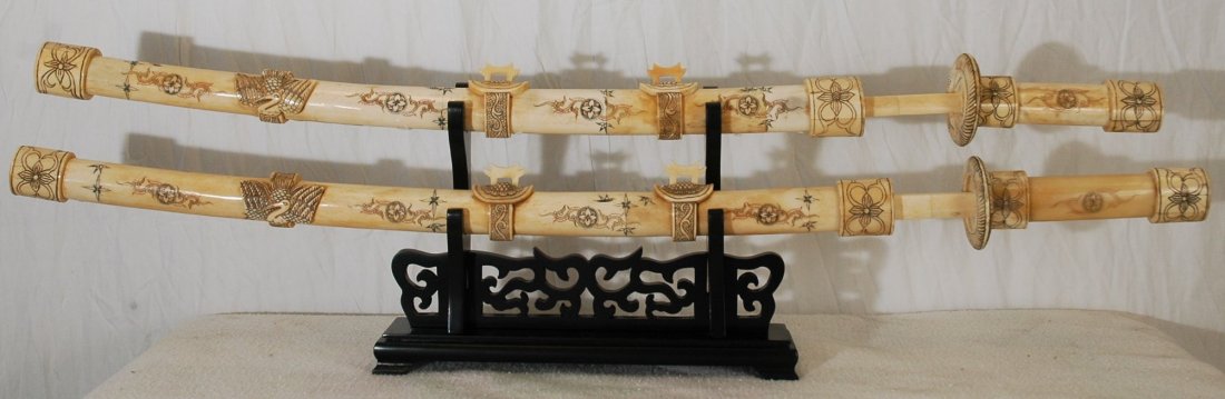 Pair of Carved Bone Swords on Stand: Pair of Carved Bone Swords on Rosewood Stand 36" & 33" long; blade is also bone.