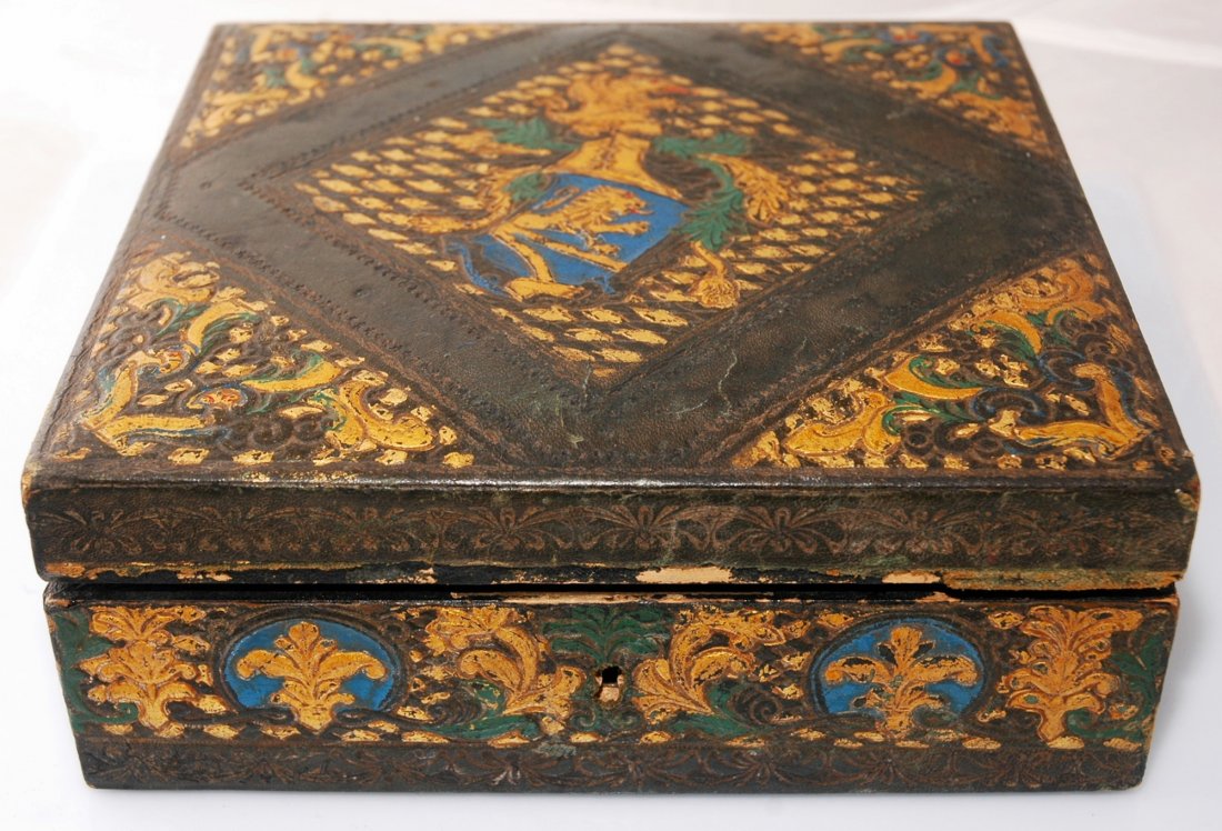 Vintage Leather covered wooden box: Vintage Leather covered wooden box. Armor Lion design in the cernert, fabric lining in the insid. Ripped lining by the inside hinge. 8" x 8" x 3"