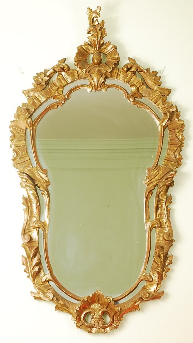 Antique Hand Carved Wooden Wall Mirror: Antique intricately hand carved wooden gold leaf colored wall mirror. 49" H x 25" L