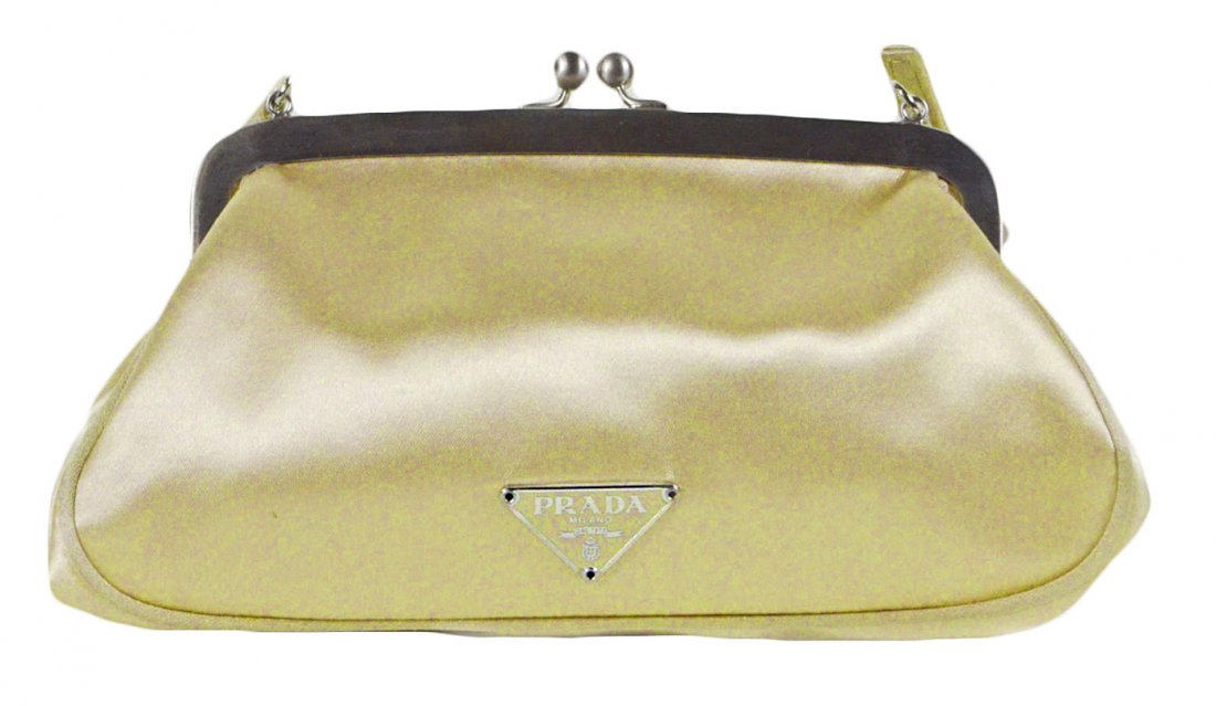 Vintage Prada Evening Clutch 4.2"Tall: Vintage prada evening clutch. Ivory cream color with metal silver clutch. Comes without a tag. Serial number 31. Includes authenticity certificate card BN0992. Another certificate comes in the small e
