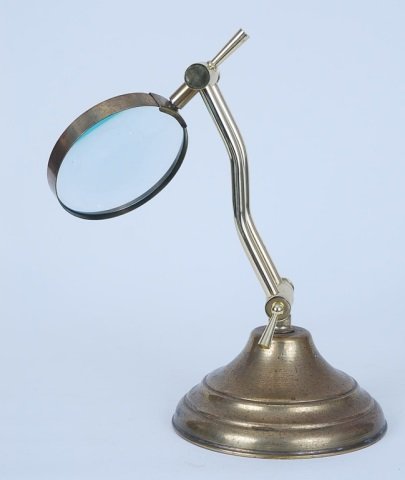 Antique Magnifying Glass on Brass Stand: Antique Magnifying Glass on Brass Stand. Measures approx. 16" tall