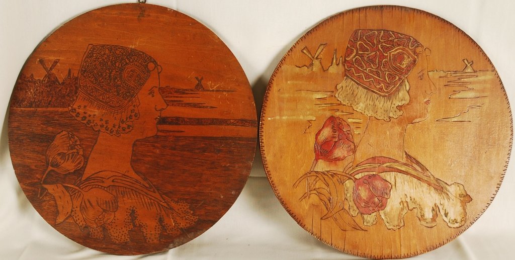 After Paul Berthon pair Wood Etchings: After Paul Berthon, pair of Wood Burning Etchings of Queen Wihelmina. Both panels are 18" across. Darker panel Is 1/2" thick and lighter panel is 5/16" thick. "Etta F, Cox 1906" stamped at back on one