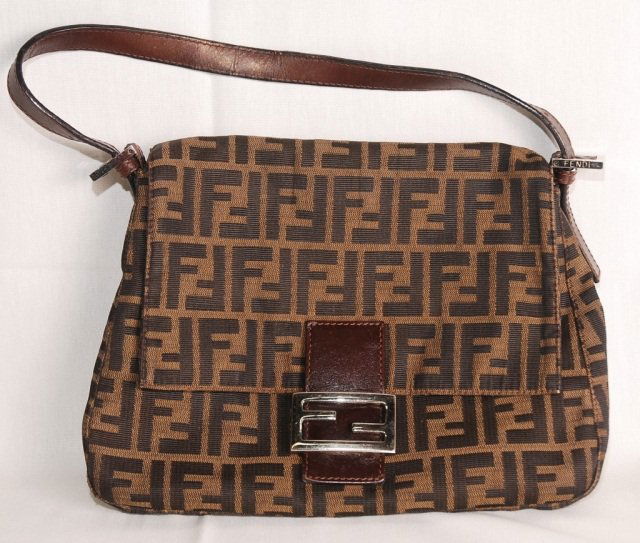 Genuine Fendi Ladies Hand Bag: Fendi Hand Bag, Dark Brown Fabric with F logo. Made in Itally. Buckled with magnetic lock. Zippered pouch inside bag. Used in good condition. Height 8" x width 11" and depth 5". Brown Leather Strap.