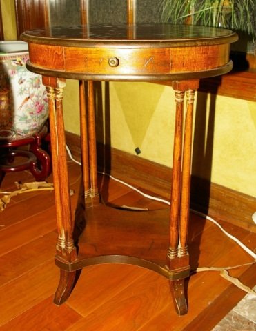 Antique Oval End Table: Antique Oval End Table, one center drawer and a bottom shelf. Measures approx 27"H x 20" x 16" Condition: Very Good, some minor surface scratches due to age. Otherwise in very good condition