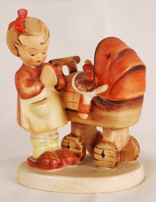 M.J. Hummel, Girl Praying with Baby in Stroller: M.J. Hummel, Girl Praying with Baby in Stroller Figurine. Made in Germany. Height 5", width 4". Numbered 67.