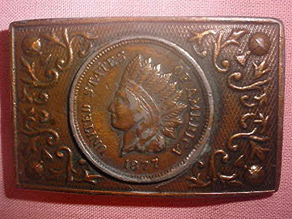 Tiffany Studio Bronze Belt Buckle Indian Penny: features an Indian and has United States Of America 1877 written. It measures approx. 3-1/4 inches wide x 2-1/8 inches high.