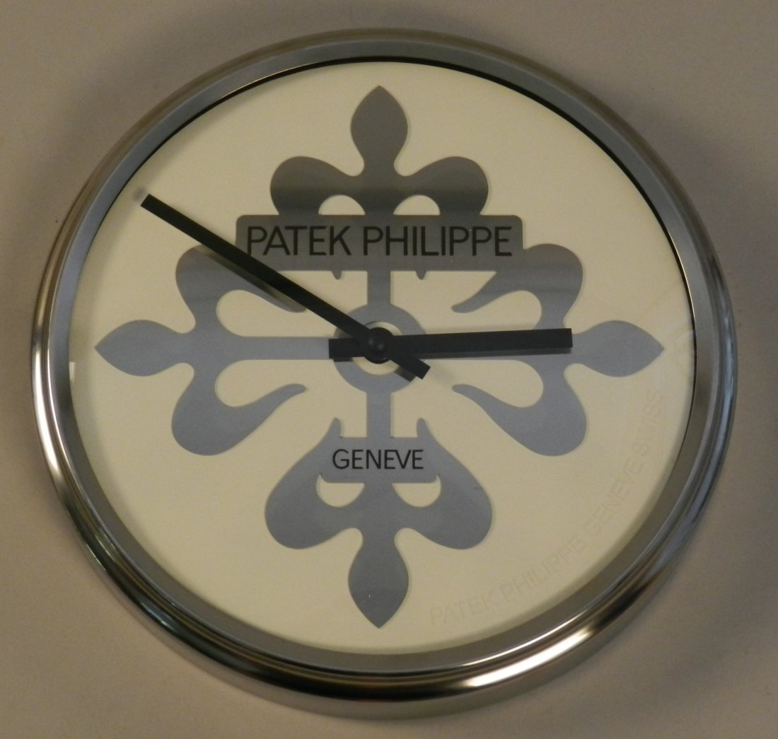 Patek Phillipe Geneve Dealer Showroom Clock: Measures: 12 inches Patek Philippe world time dealer wall clock, battery operated with a fluid second hand movement steel case.