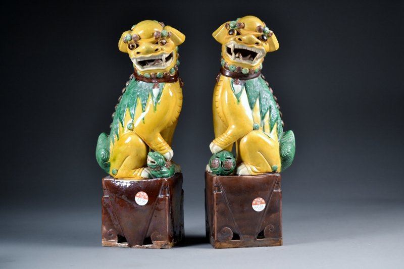 pair of Chinese republic porclain foo dogs, male a: pair of Chinese republic porclain foo dogs, male and female yellow and green glaze brown base Size: 16 3/4 Tall x 6 1/2 " wide
