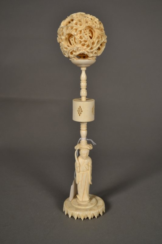 Ivory Puzzle Ball With Ivory Stand: Intricately carved ivory puzzle ball with carved ivory stand. 11 1/2" tall, including stand.
