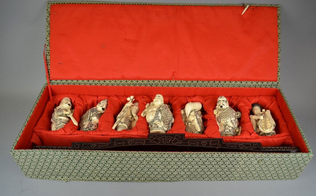 A Set of Seven Japanese Carved Bone Figures 20th: 20th century The carved, scrimshawed bone figures with polychromed accents throughout, depicting the Immortals, and raised on the accompanying large carved, wire inlaid wood stand. Size: 6" height (ea