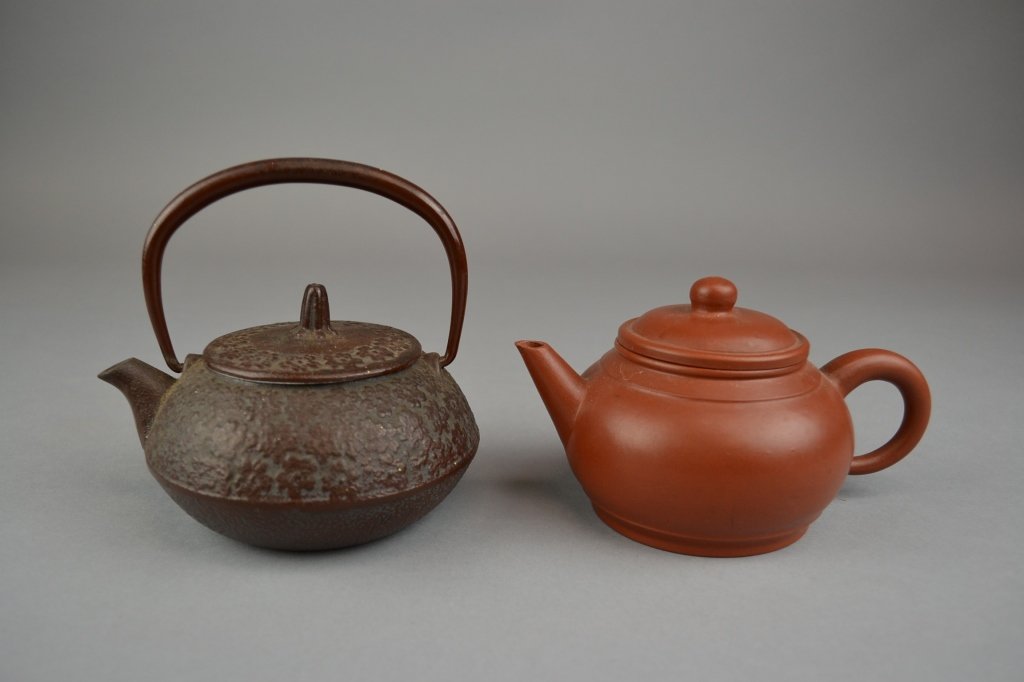 Yixing and Iron Teapots (1) Yixing pottery teapot 6" x: (1) Yixing pottery teapot 6" x 3 1/2" (2) Iron teapot 5" x 4 1/2"