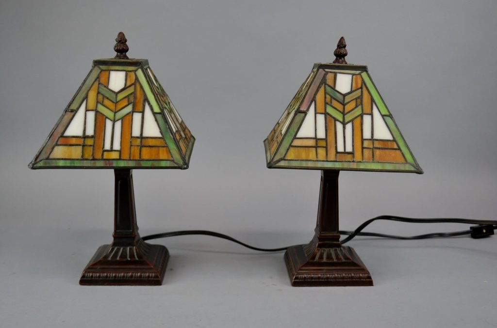 Pair of Arts & Craft Style Lamps This pair of lamps: This pair of lamps have a four sided leaded glass lampshade that sits on a bronze square base. 12 1/2" x 7"