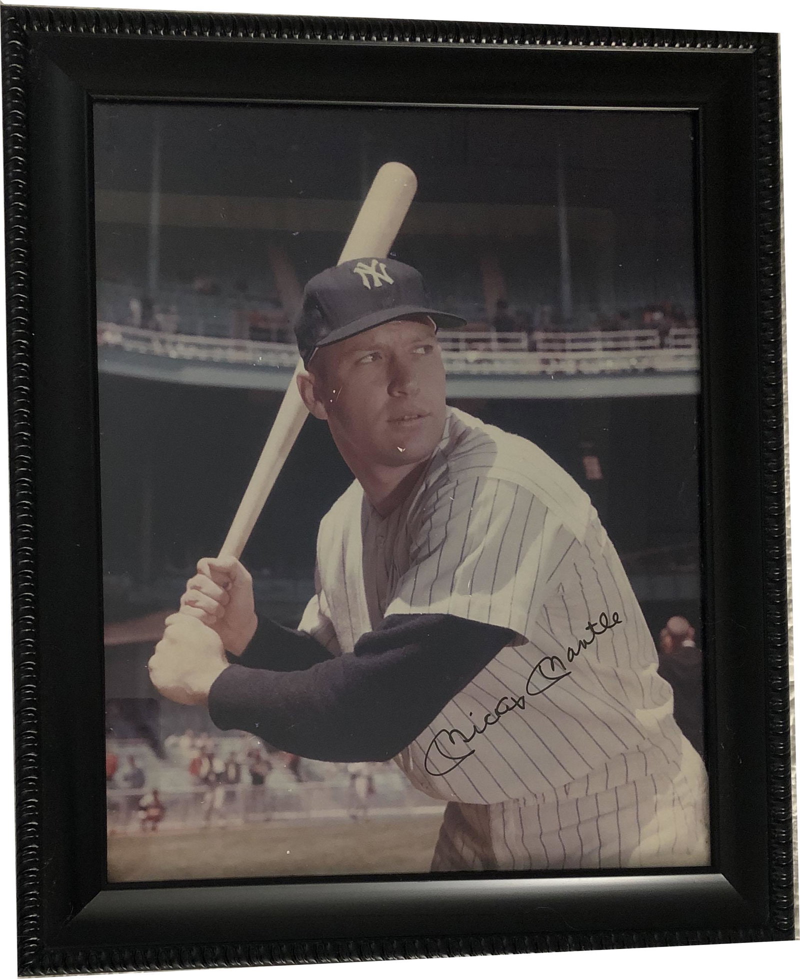 Large Mickey Mantel Photo with Autograph and COA: Large Mickey Mantel Photo with Autograph and COA; Mickey Mantel wearing his pinstrip uniform in batting postion with Black Frame; slight photo damage near face. Certificate of Authenticity; AVAILABLE 