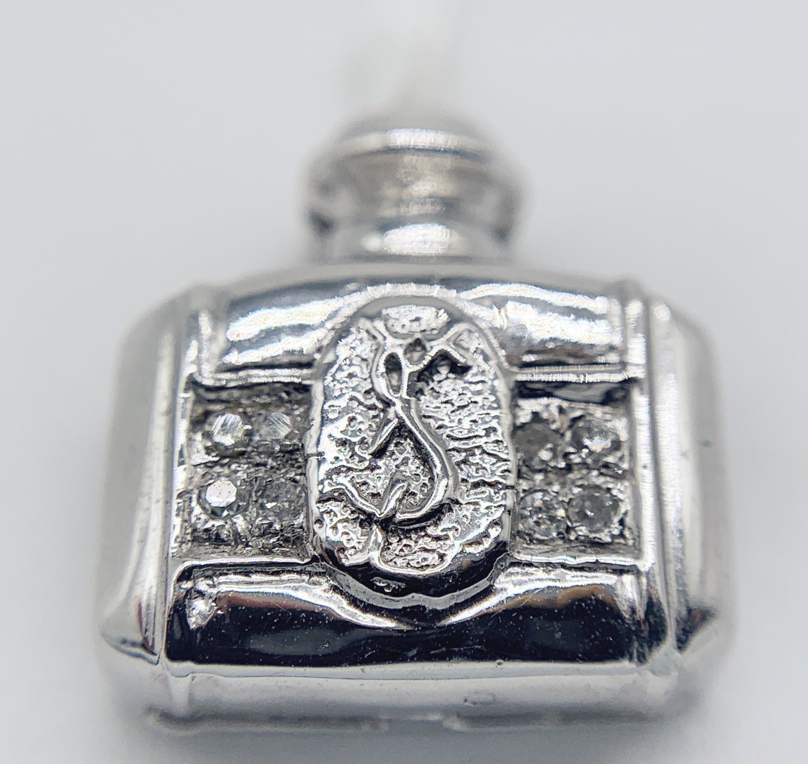 18kt White Gold "YSL Bottle" Pendant: 18kt White Gold "YSL Bottle" Pendant weighing ~ 2.1 grams. THIS ITEM IS LOCATED AND SHIPPING FROM CORONA DEL MAR, CA.