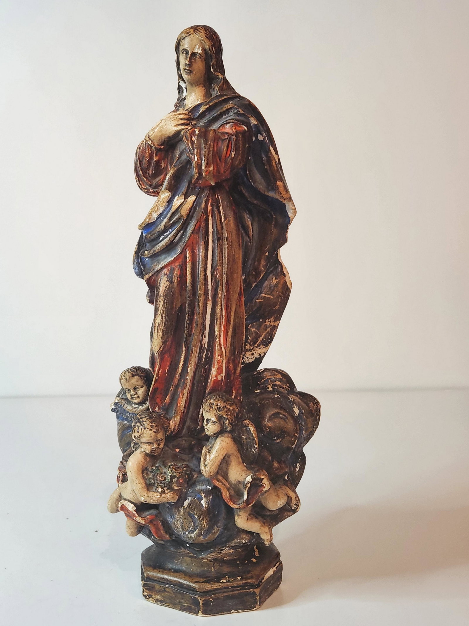 Statue of the Immaculate Conception Sculpture: This is a Statue of the Immaculate Conception Religious Sculpture. The Catholic figurine features the Assumption of Mary after the famous painter Esteban Murillo. Complete with Angels around her feet.