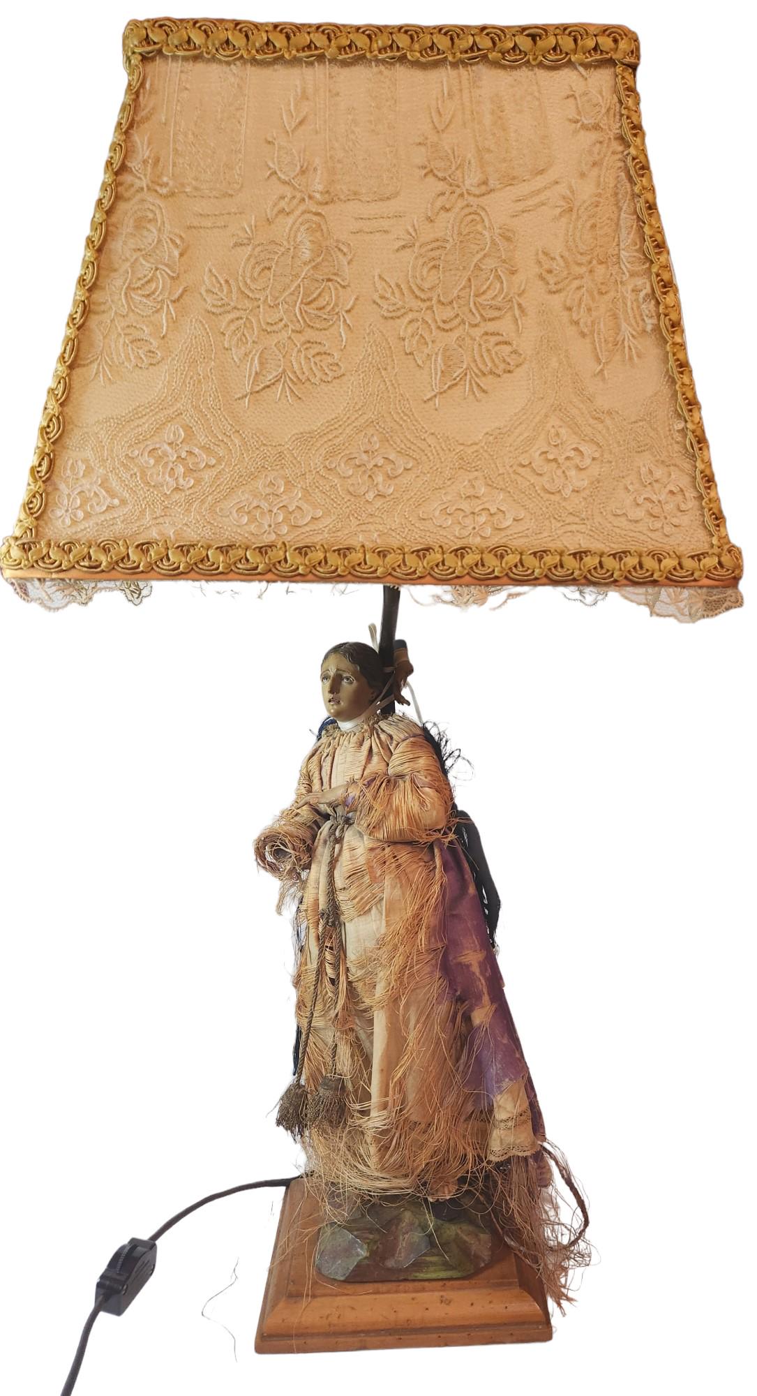 Religious Woman Lamp: Religious Woman (possiably Virgin Mary) Lamp. Figure is about 13in x 6in. The lamp is about 24in x 10inx 6in. From the Estate of Sonia Rivelli Jiavis, Las Vegas, NV.