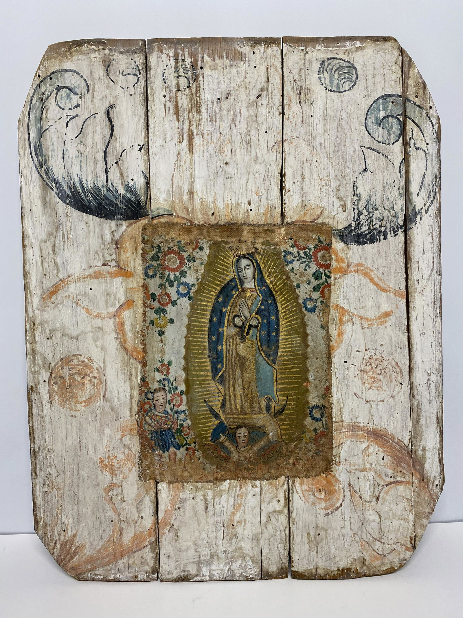 Spanish Colonial Mexican "Lady of Guadalupe" Wooden/Fabric Retablo: Spanish Colonial Mexican "Lady of Guadalupe" Wooden/Fabric Retablo - Depicts Our Lady of Guadalupe with flowers around her image and children can be seen underneath. The art is made on fabric and atta