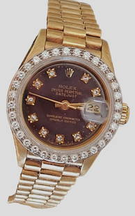 Rolex 18K Yellow Gold Vintage Ladies Oyster Perpetul Diamond Presidential Watch: Ladies 18K Rolex Watch - Oyster Perpetual Datejust with 18K hidden clasp president style bracelet. Watch ha black diamond dial with 10 round diamonds. Also with 32 round diamonds white gold bezel