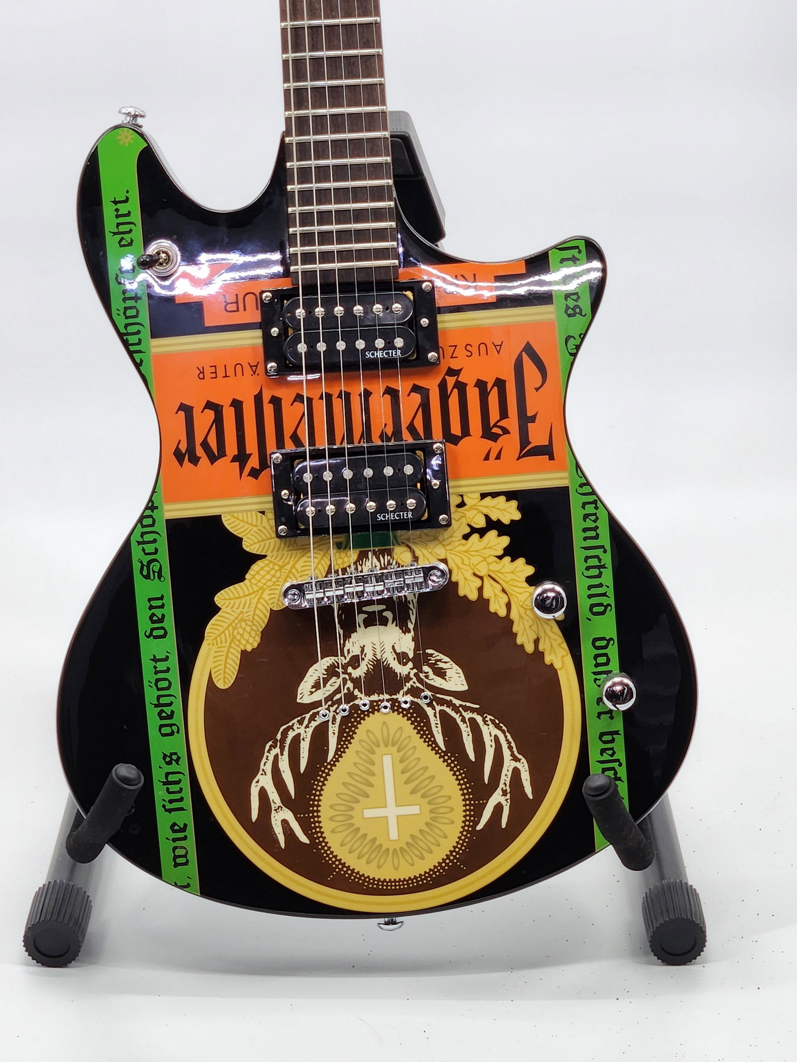 Schecter Jagermeister Guitar: This Guitar Features Country: China, Neck Type: Bolt On, Body Wood: Mahogany, Tail: Stoptail, Neck Wood: Maple, Fretboard Wood: Rosewood, Inlays: MOP Jagermeister, Inlay Down The Fretboard, Bound Neck