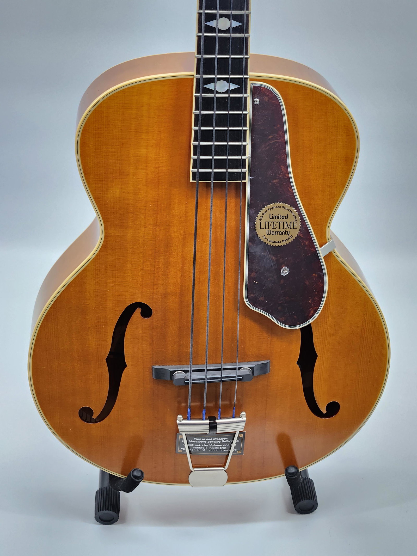 Epiphone Deluxe Masterbuilt Acoustic-Electric Guitar: Build solid spruce top with f-holes and longitudinal bracing, laminated flame-maple back and sides, set five- piece mahogany/maple rounded C neck, bone nut, ebony fingerboard with notched diamond mark