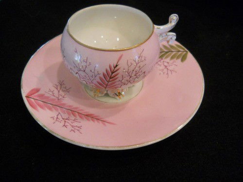 TEA CUP AND SAUCER, PINK AND WHITE #907/9653: TEA CUP AND SAUCER, PINK AND WHITE WITH PINK AND GREEN FERN DESIGN #907/9653 MARKED ON BOTTOM APPROX 6.5"DIAMETER PLATE APPROX 4"WIDE X 3"TALL TEA CUP