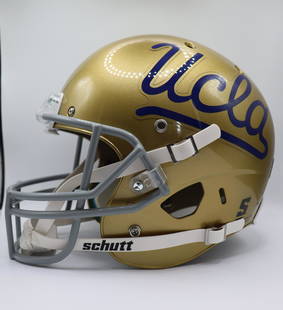 UCLA Bruins College Football Helmet: Trademark Gold UCLA Helmet with Navy Blue Insignia of UCLA and Bruins. Gray Face Guard with white Schutt straps. Ships from Newport Beach. V.